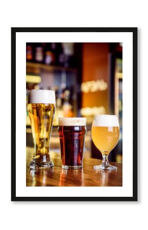 Glass of light and dark beer on a pub with bokeh background