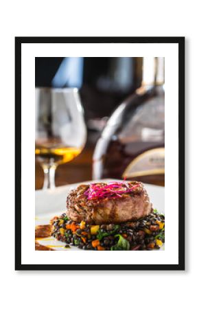 Beef Steak. Grill beef steak black lentils mixed with vegetable. Cognac or brandy as drink. Culinary food in hotel pub or restaurant