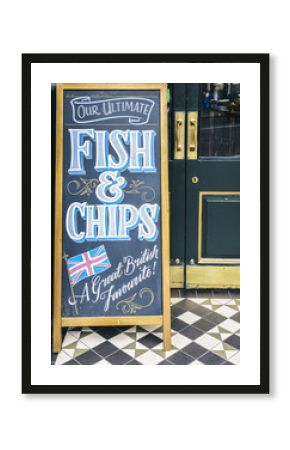 Sign on blackboard outside a pub in London promoting their Ultimate Fish and Chips, a great British favourite.