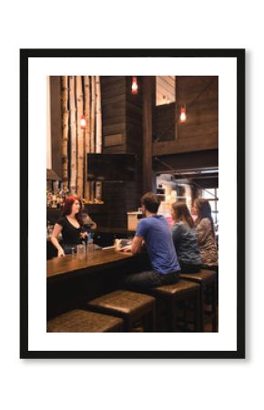 Bartender interacting with customers