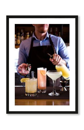 Bartender pouring cocktails at the bar