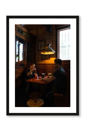 Couple enjoying drinks at traditional irish pub