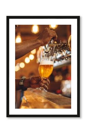Bartender pours draft beer into tilted glass, warm bar lighting, golden foam, cinematic vibe.