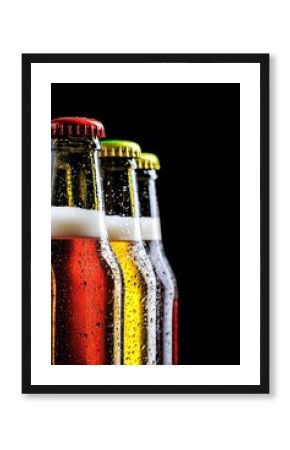 Refreshing beer bottles covered with condensation on black background