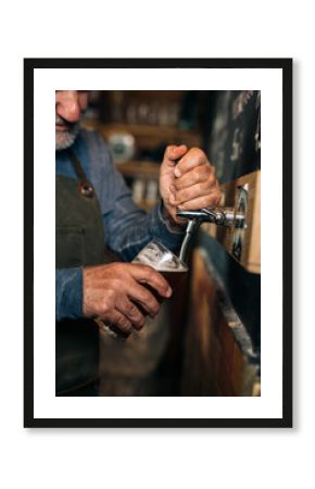 middle aged man bartender serving beer in beer pub