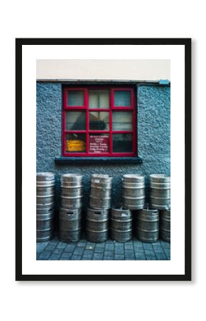 beer kegs outside window of old Irish pub