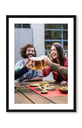 Group Of young Friends Enjoying Beer Drinks In Bar