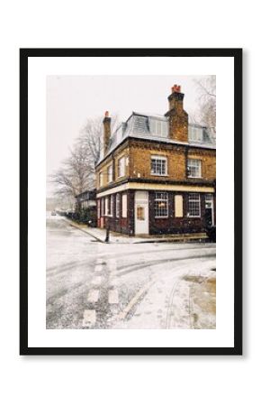 London pub building in winter on a snowy day.