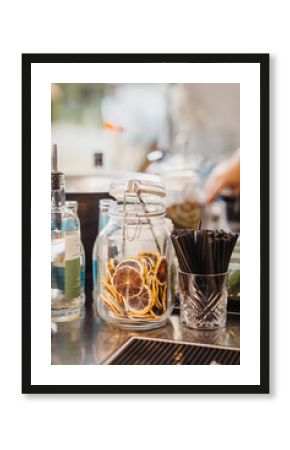 Outdoor bar with shots, shaker, sugar and other cocktail ingredients