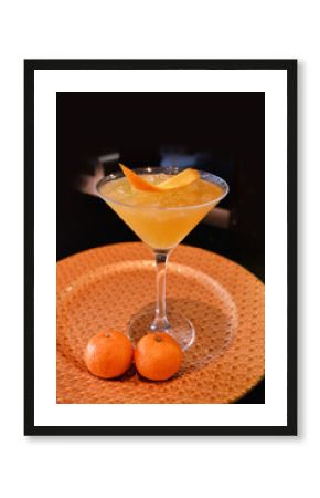 chilled cocktail mocktail glass wine with mandarin orange fruit juice kombucha vodka alcohol cinnamon longan drink on gold plate dark background bar cuisine menu for hotel pub