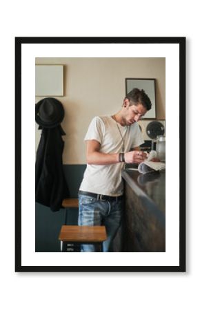 Bartender, writing and clipboard for stock management with restaurant, inventory or check for liquor. Man, barman and checklist with thinking, order or inspection for alcohol, invoice or notes at pub