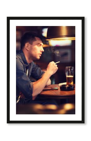 man drinking beer and smoking cigarette at bar