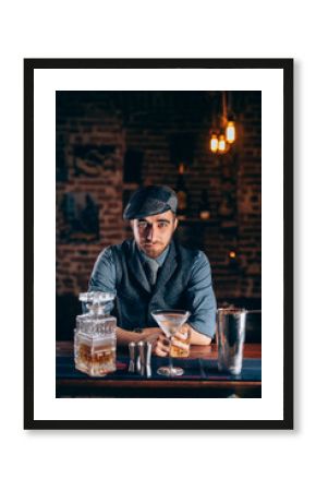 Vintage man enjoying a relaxing old fashioned drink at bar.