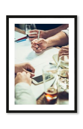 The hands of people working and relaxing in pub.
