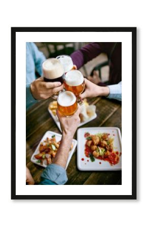 Drinking Beer. Friends Raising Glasses Of Beer