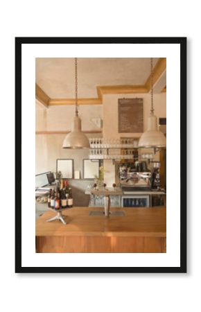 Espresso machine, glasses and bottles behind vintage cafe counter