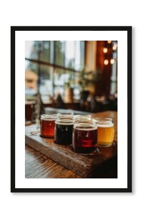 A flight of craft beers on a wooden board in a pub setting with a blurred background and natural light
