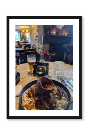 sunday lunch in English pub around cosy fire 