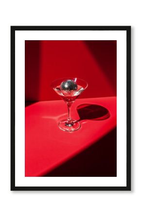 Cocktail party with disco ball on sunset coral color background. Disco party, retro fashion. Modern stylish banner template for holiday card, banner, flyer, menu with space for text
