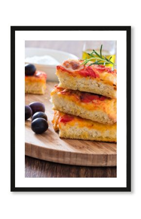 Focaccia with tomato and black olives.