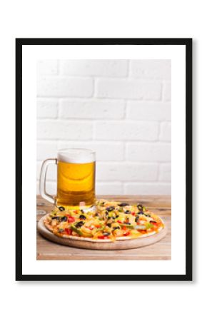 pizza on the table with a glass of beer