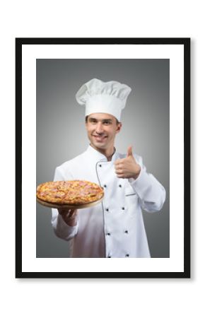 Smiling chef with fresh pizza showing thumbs up