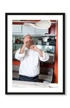 Chef throwing the pizza base dough