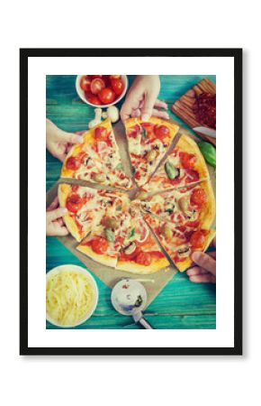 Family takes pieces of pizza