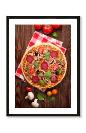 Italian pizza with pepperoni, tomatoes, olives and basil