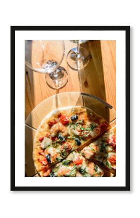 Wineglasses and fresh baked pizza