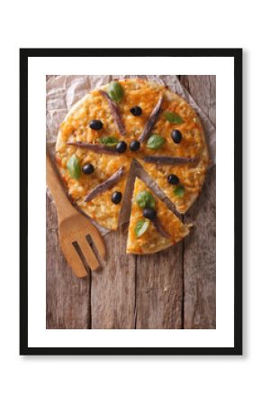 Sliced pizza with anchovies and onions. vertical top view  