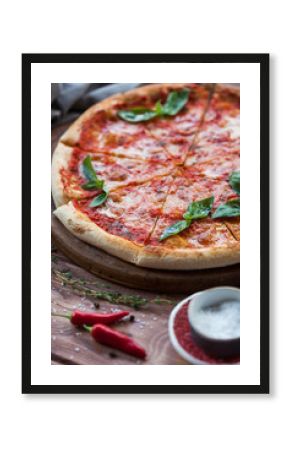 Italian pizza with basil leaves