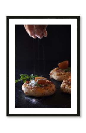 Mini Pizzas Over a Black Board