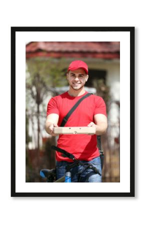 Young man with bike delivering pizza