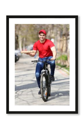 Young man with bike delivering pizza