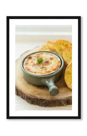 baked pizza dip with Garlic bread.selective focus.