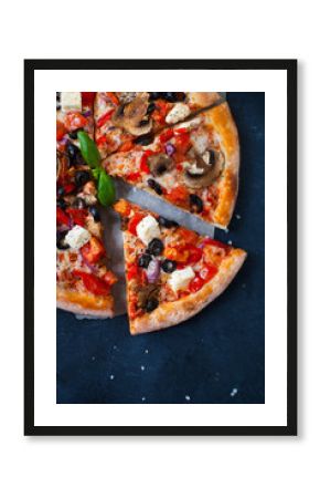Homemade pizza with tomatoes, mozzarella and basil. Top view with copy space on dark concrete background.