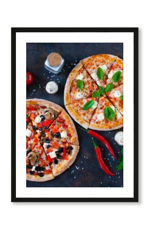 Hot testy pizza with tomatoes, mozzarella, mushrooms, olives, red pepper and basil on black concrete background. Copyspace. Top view.