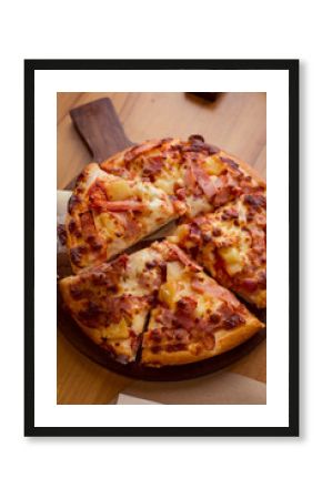 Hawaiian Pizza on wooden table.