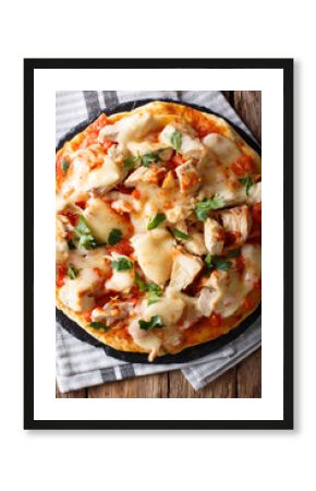 American pizza with chicken, tomatoes, buffalo sauce and cheese close-up. vertical top view