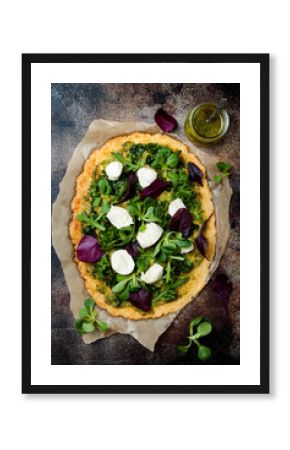 Cauliflower pizza crust with pesto, kale, mozzarella cheese and greens
