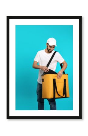 Young courier with thermo bag on color background. Food delivery service