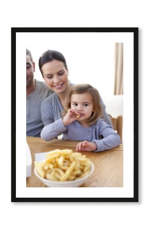 Little girl eating fries and pizza at home