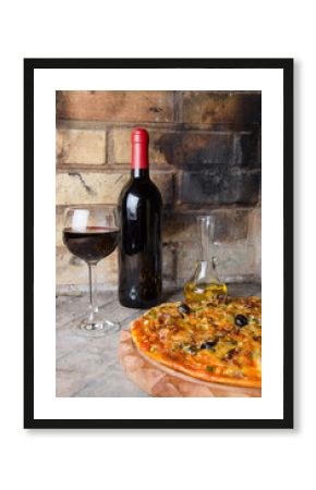Pizza with wine and oil on a firebricks background