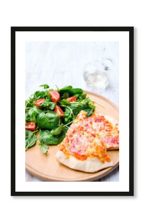 Two slices of pizza with side salad