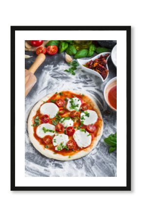 Prepering margherita pizza with mozzarella for baking