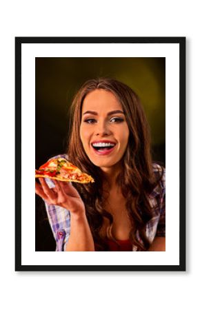 Woman eating slice of Italian pizza . Student consume fast food. Healthy eating and diet concept on black background.