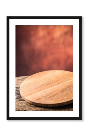 Empty pizza round board  old wooden table and colour blurred background