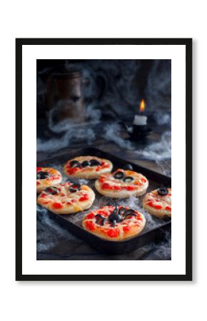 Mini pizzas decorated with spiders and mummies for a Halloween