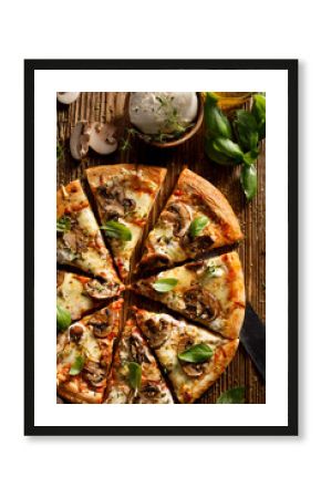 Mushroom pizza with addition mozzarella cheese and herbs on a wooden table, top view. Pizza slice